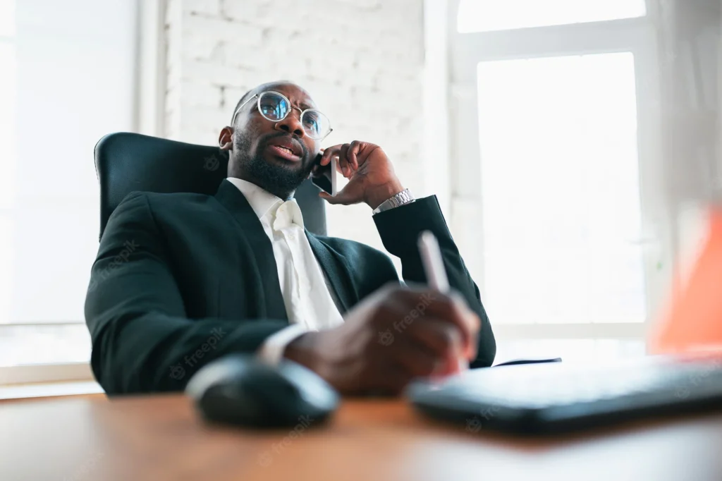 calling talking phone african american entrepreneur businessman working concentrated office looks serios busy wearing classic suit concept work finance business success leadership 155003 38896